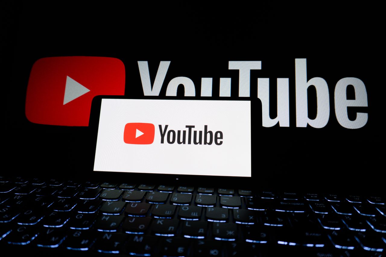 creative-02 Close-up of YouTube logo displayed on a laptop screen in a dark environment.